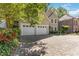 Wide, patterned brick driveway leading to a home with a two-car garage surrounded by vibrant greenery at 2651 Briarlake Ne Rd, Atlanta, GA 30345