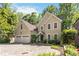 Elegant home featuring a circular driveway, two-car garage, and lush landscaping at 2651 Briarlake Ne Rd, Atlanta, GA 30345