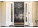 Elegant black front door framed by stained-glass sidelights and stately white pillars at 2651 Briarlake Ne Rd, Atlanta, GA 30345