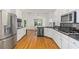 Modern kitchen featuring white cabinets, stainless steel appliances, and hardwood floors at 2651 Briarlake Ne Rd, Atlanta, GA 30345