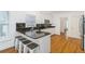 Bright kitchen featuring an island with bar seating, granite countertops, and modern appliances at 2651 Briarlake Ne Rd, Atlanta, GA 30345