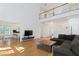 Open concept living room with hardwood floors, a fireplace, and a view of the upper level at 2651 Briarlake Ne Rd, Atlanta, GA 30345