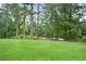 Expansive grassy backyard lined with mature trees and foliage at 2738 Westchester Dr, Atlanta, GA 30344