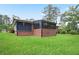 Large backyard featuring a brick home with painted trim, healthy lawn and mature trees at 2738 Westchester Dr, Atlanta, GA 30344
