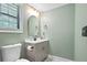 Bathroom featuring modern vanity, oval mirror and unique floor tiling at 2738 Westchester Dr, Atlanta, GA 30344