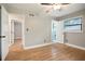 Bright bedroom features hardwood floors, a ceiling fan, a window, and ensuite bathroom access at 2738 Westchester Dr, Atlanta, GA 30344