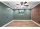 Bedroom with stylish color scheme features hardwood floors, a ceiling fan, and large window at 2738 Westchester Dr, Atlanta, GA 30344