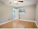 Bright bedroom features hardwood floors, a ceiling fan, a window, and ensuite bathroom access at 2738 Westchester Dr, Atlanta, GA 30344