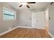Bedroom with hardwood floors features a ceiling fan, closet, and large window at 2738 Westchester Dr, Atlanta, GA 30344