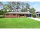 Charming brick home with a well-manicured lawn and a vibrant, yellow front door provides great curb appeal at 2738 Westchester Dr, Atlanta, GA 30344