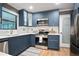 Charming kitchen featuring navy cabinets, stainless steel appliances, and white countertops at 2738 Westchester Dr, Atlanta, GA 30344