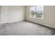 Bedroom with one window, white door and carpeted flooring at 4129 Flakes Mill Manor Ln, Ellenwood, GA 30294