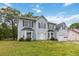 Light blue two-story home with a garage, bay windows and a well-manicured lawn at 4129 Flakes Mill Manor Ln, Ellenwood, GA 30294