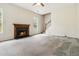 Living room showing fireplace, staircase to an upper floor, ceiling fan and a window at 4129 Flakes Mill Manor Ln, Ellenwood, GA 30294