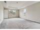 Spacious main bedroom with white walls, gray carpet, tray ceiling and natural light from two windows at 4129 Flakes Mill Manor Ln, Ellenwood, GA 30294