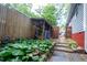 Garden area featuring lush greenery, a small shed, and a stone-paved path at 959 Berne Se St, Atlanta, GA 30316