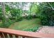 Picturesque backyard showcasing a well-maintained lawn, mature trees, and lush landscaping at 959 Berne Se St, Atlanta, GA 30316