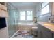 Clean bathroom featuring a glass-enclosed shower and soaking tub at 959 Berne Se St, Atlanta, GA 30316