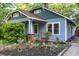 Charming blue home with a well-manicured front yard and inviting covered porch area at 959 Berne Se St, Atlanta, GA 30316