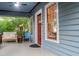 Welcoming front porch with seating, complemented by the home's charming blue siding and red trim at 959 Berne Se St, Atlanta, GA 30316