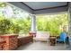 Inviting front porch features brick pillars, a birdhouse, bench seating, and pleasant green views at 959 Berne Se St, Atlanta, GA 30316