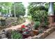 Charming front yard with potted plants and stonework, leading to a welcoming porch and blue home exterior at 959 Berne Se St, Atlanta, GA 30316