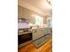 Well-lit kitchen with stainless steel stove, gray cabinets, and hardwood floors at 959 Berne Se St, Atlanta, GA 30316