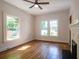Sunlit living room featuring hardwood floors, fireplace, and modern ceiling fan at 959 Berne Se St, Atlanta, GA 30316