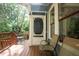 Inviting covered porch with wood flooring, seating, and a charming screen door entry to the residence at 959 Berne Se St, Atlanta, GA 30316