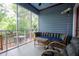 Relaxing screened porch featuring comfortable seating, a ceiling fan, and serene views of the surrounding greenery at 959 Berne Se St, Atlanta, GA 30316