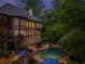 Aerial view of a home's backyard oasis, complete with pool, outdoor dining, and lush landscaping at 106 Stephens Farm Dr, Canton, GA 30115