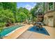 Spacious backyard with a swimming pool, patio area, and outdoor dining offers the perfect setting for outdoor enjoyment at 106 Stephens Farm Dr, Canton, GA 30115