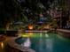 Tranquil backyard oasis with a freeform pool, outdoor fireplace, and multi-level deck for evening relaxation at 106 Stephens Farm Dr, Canton, GA 30115