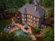 Aerial view of a backyard with a large pool, patio, and lush landscaping, perfect for outdoor entertaining at 106 Stephens Farm Dr, Canton, GA 30115