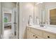 Bathroom featuring double doors, a large mirror, white cabinets, and tile flooring at 106 Stephens Farm Dr, Canton, GA 30115