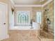 Elegant bathroom featuring a soaking tub, glass shower, and decorative window at 106 Stephens Farm Dr, Canton, GA 30115