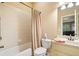 Bright bathroom featuring a tub and shower combination, white vanity, and neutral tones at 106 Stephens Farm Dr, Canton, GA 30115