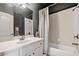 Cozy bathroom features a shower-tub combo, white vanity and updated fixtures at 106 Stephens Farm Dr, Canton, GA 30115