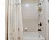 Bathroom showcasing a white bathtub with a shower curtain and tiled wall at 106 Stephens Farm Dr, Canton, GA 30115