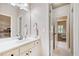 Bathroom with white cabinets, a large mirror, and a view into a bedroom with natural light at 106 Stephens Farm Dr, Canton, GA 30115