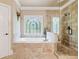 Bright bathroom with a soaking tub under a stained glass window, and a separate shower at 106 Stephens Farm Dr, Canton, GA 30115