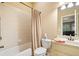 Neutral bathroom featuring a shower-tub combo with tile surround, and a single sink vanity at 106 Stephens Farm Dr, Canton, GA 30115