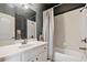 Well-lit bathroom featuring a tub/shower combo with tile surround, stylish vanity, and modern fixtures at 106 Stephens Farm Dr, Canton, GA 30115