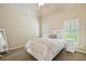Bedroom with neutral walls, carpet, and white bedding, complemented by natural light from shuttered windows at 106 Stephens Farm Dr, Canton, GA 30115