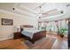 Spacious bedroom with tray ceiling, hardwood floors, bay window, and natural light at 106 Stephens Farm Dr, Canton, GA 30115