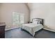 Cozy bedroom with a bed, dark blue carpet, and large window at 106 Stephens Farm Dr, Canton, GA 30115