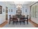 Chic dining area featuring a table set for six, complemented by a stylish light fixture at 106 Stephens Farm Dr, Canton, GA 30115