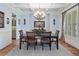 Elegant dining room with soft blue walls, wainscoting, and a stylish chandelier at 106 Stephens Farm Dr, Canton, GA 30115