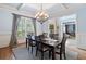 Formal dining room featuring a coffered ceiling, stylish chandelier, and hardwood floors at 106 Stephens Farm Dr, Canton, GA 30115