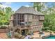 Beautiful home exterior with a multi-level deck, screened porch, and patio with a pool at 106 Stephens Farm Dr, Canton, GA 30115